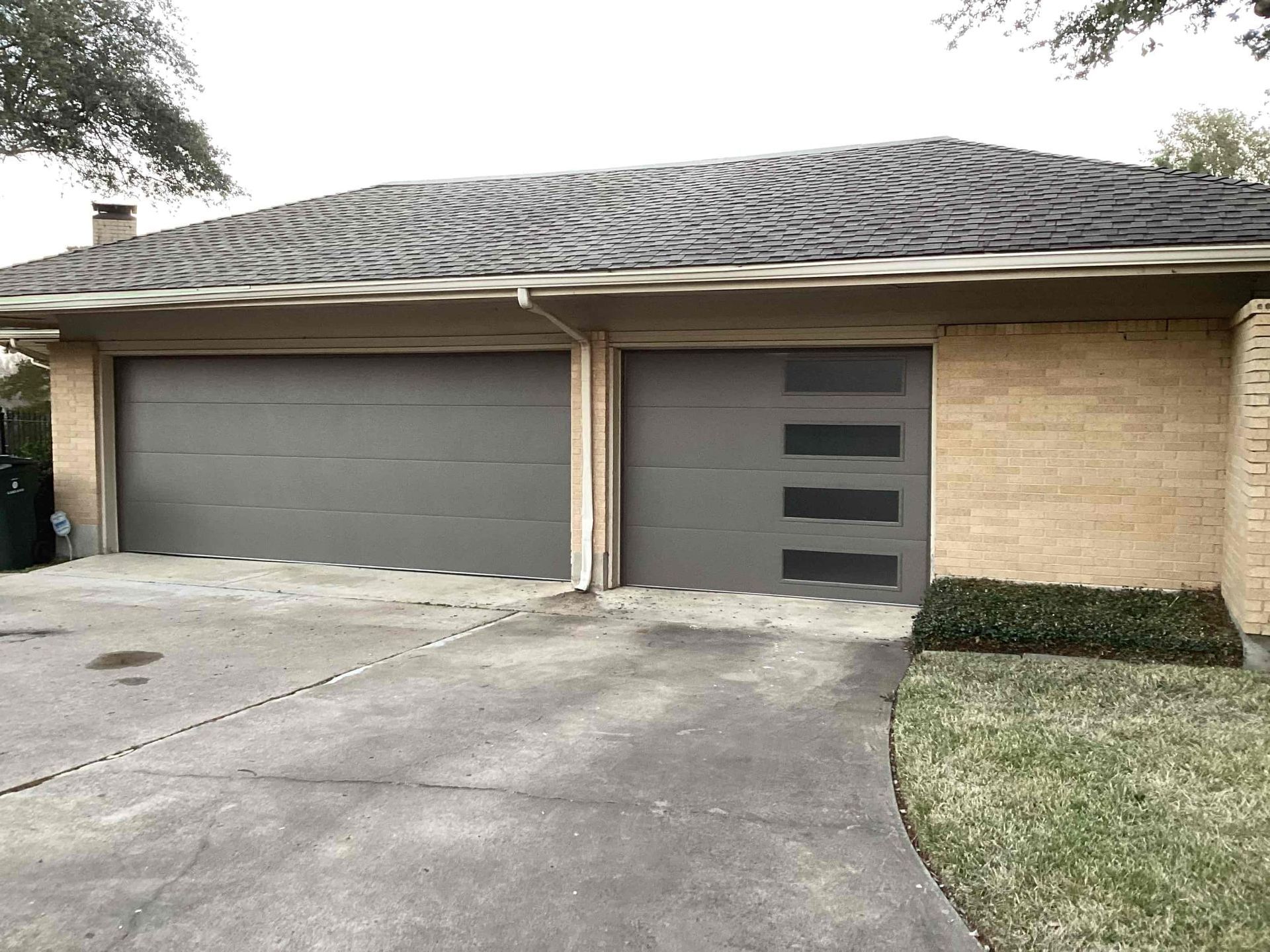 A house with two garage doors and a driveway.