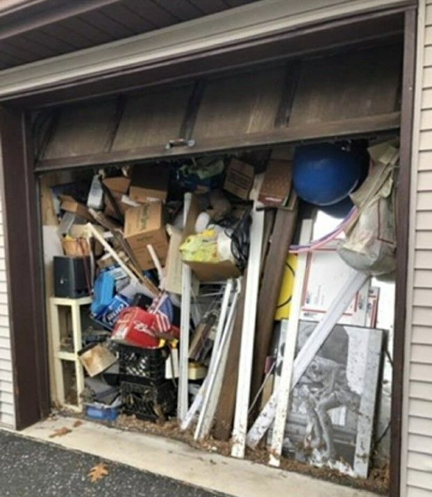 A garage filled with lots of junk and boxes