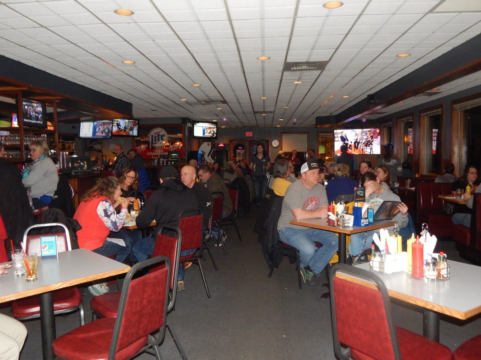 A restaurant filled with people sitting at tables and chairs