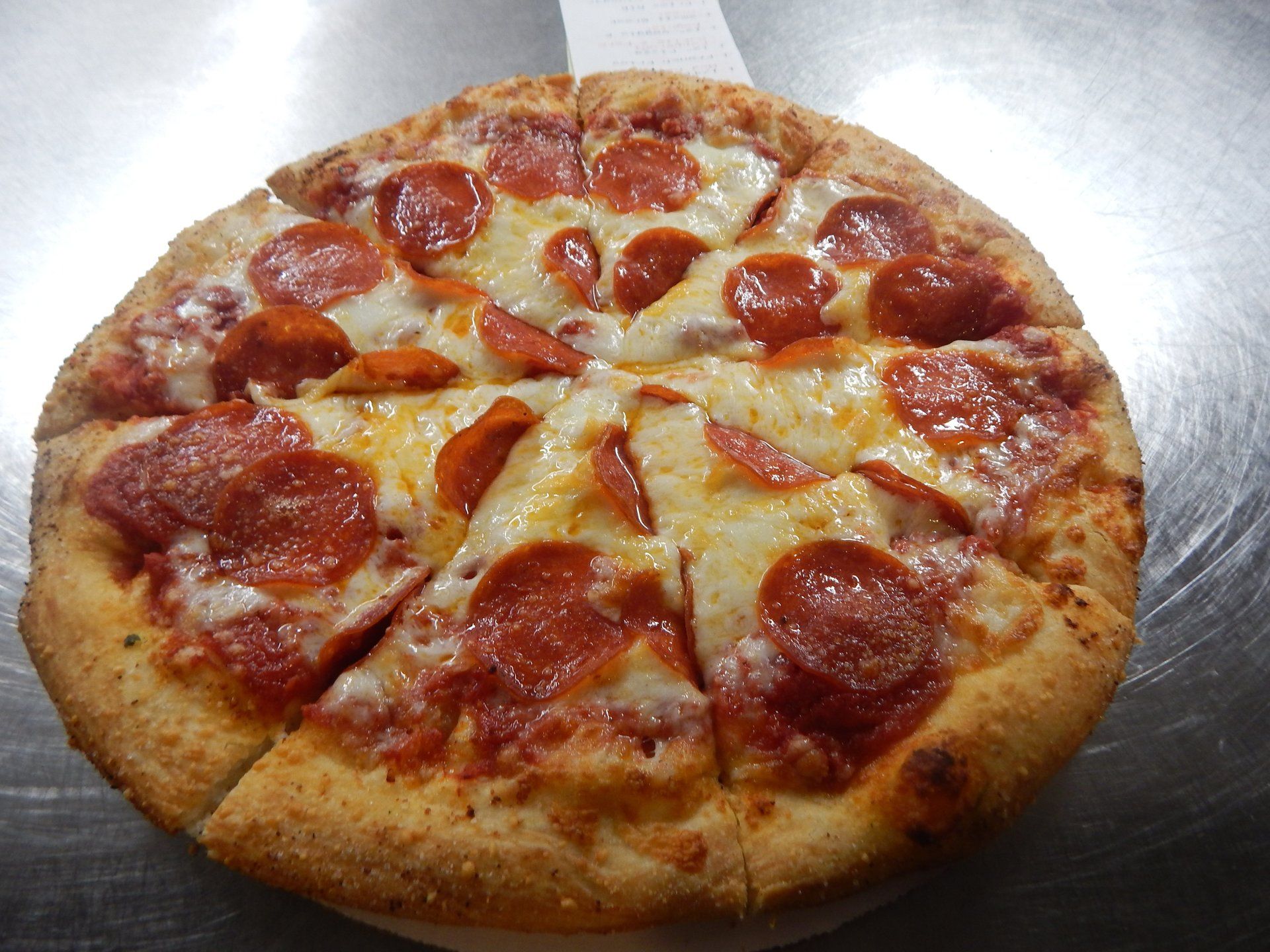 A pepperoni pizza with cheese and pepperoni on it