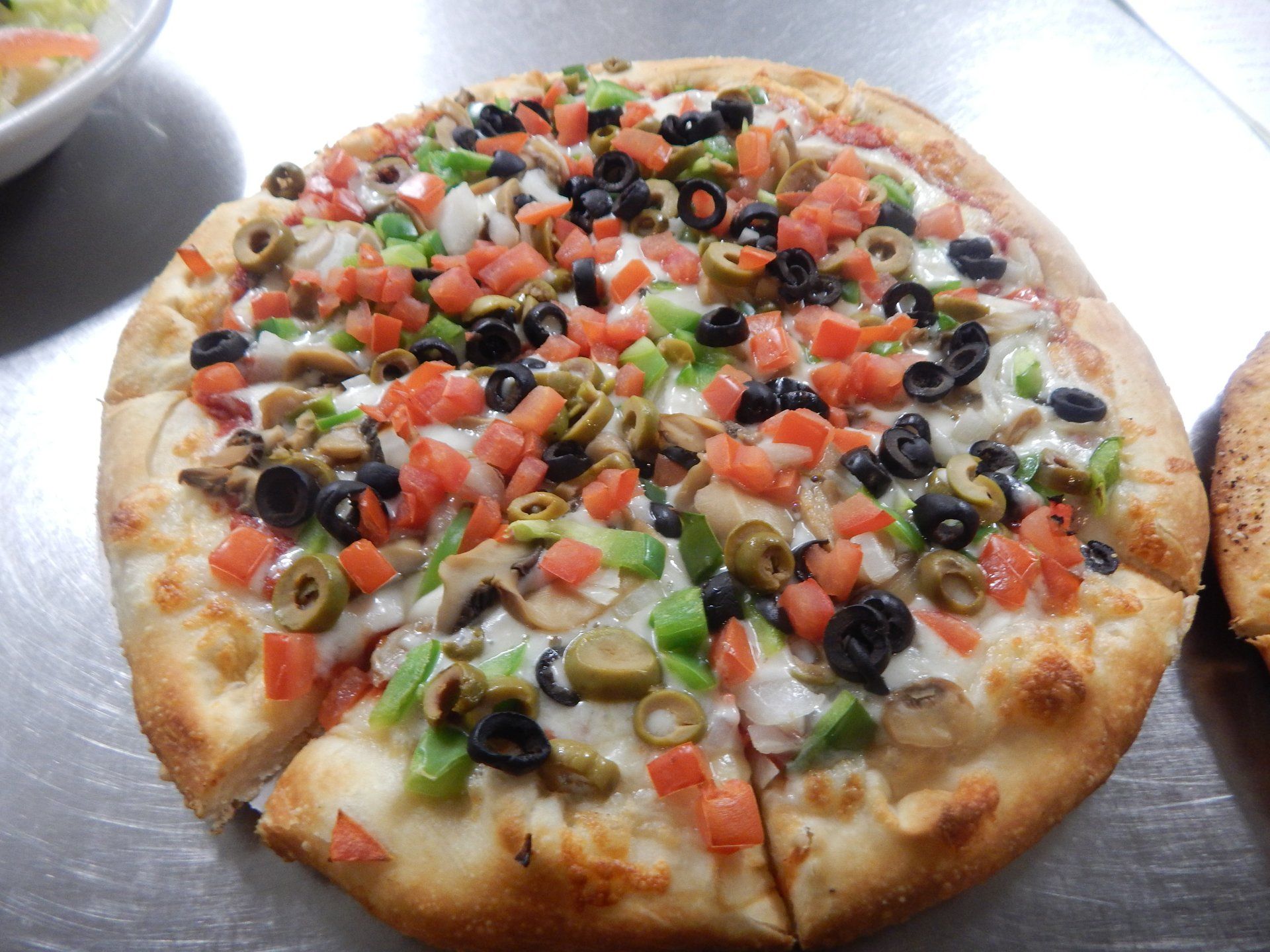 A pizza with a lot of vegetables on it