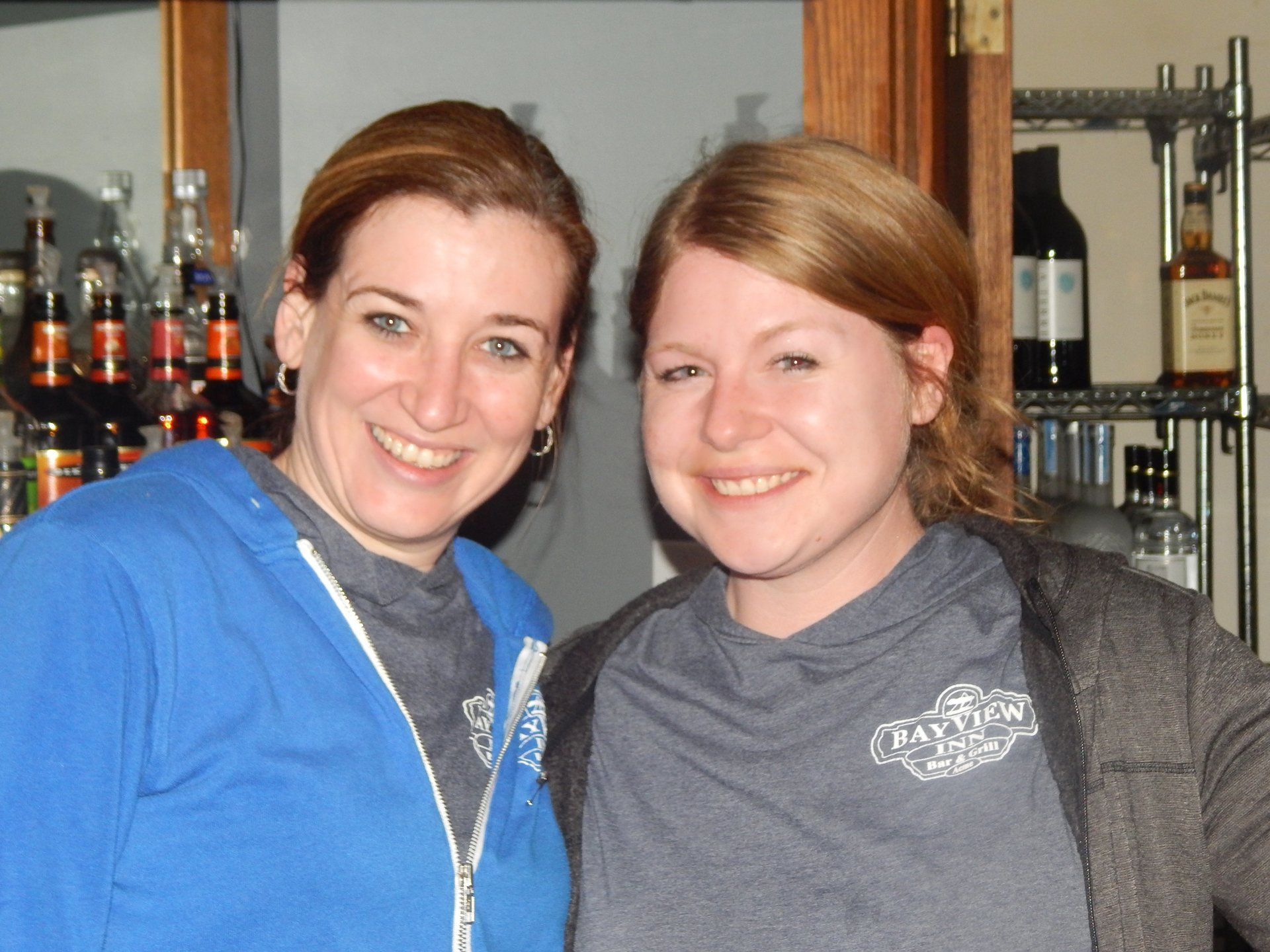 Two women posing for a picture with one wearing a shirt that says ' taylor ' on it