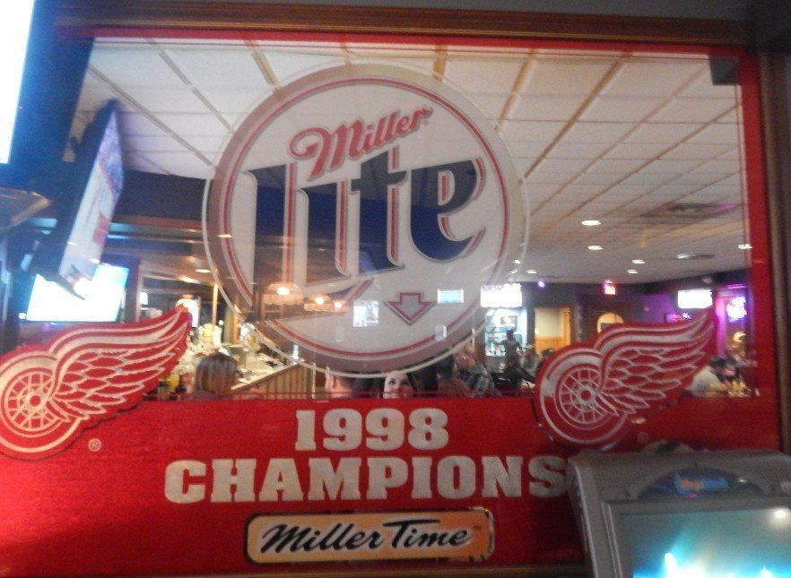 Miller lite 1998 champions sign in a window