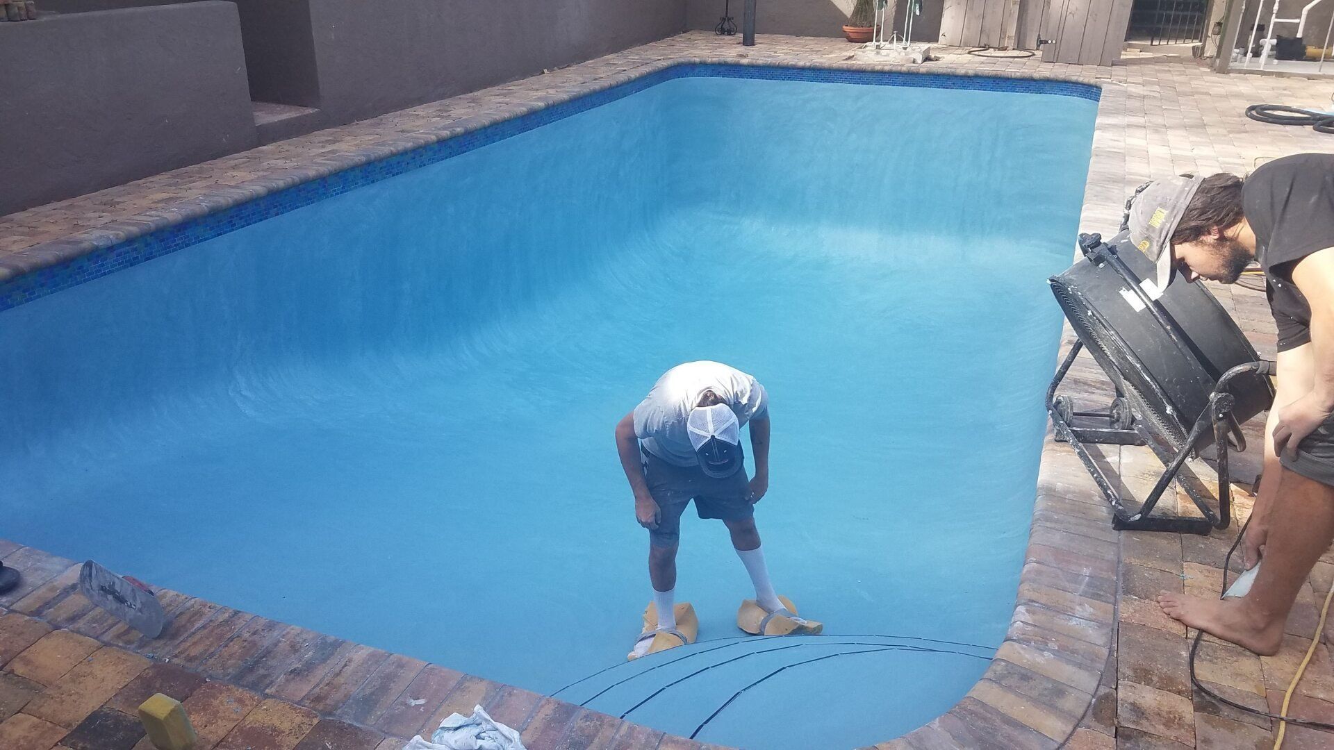 Worker Installing Pool Tiles — Ocala, FL — Sweetwater Pool & Spa Inc.