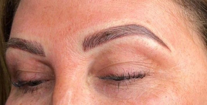 A close up of a woman 's eyebrows with her eyes closed.