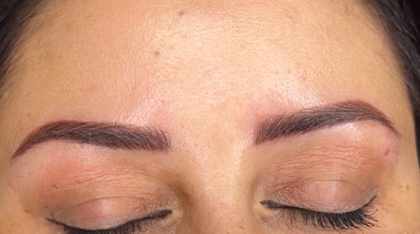 A close up of a woman 's eyebrows with her eyes closed.