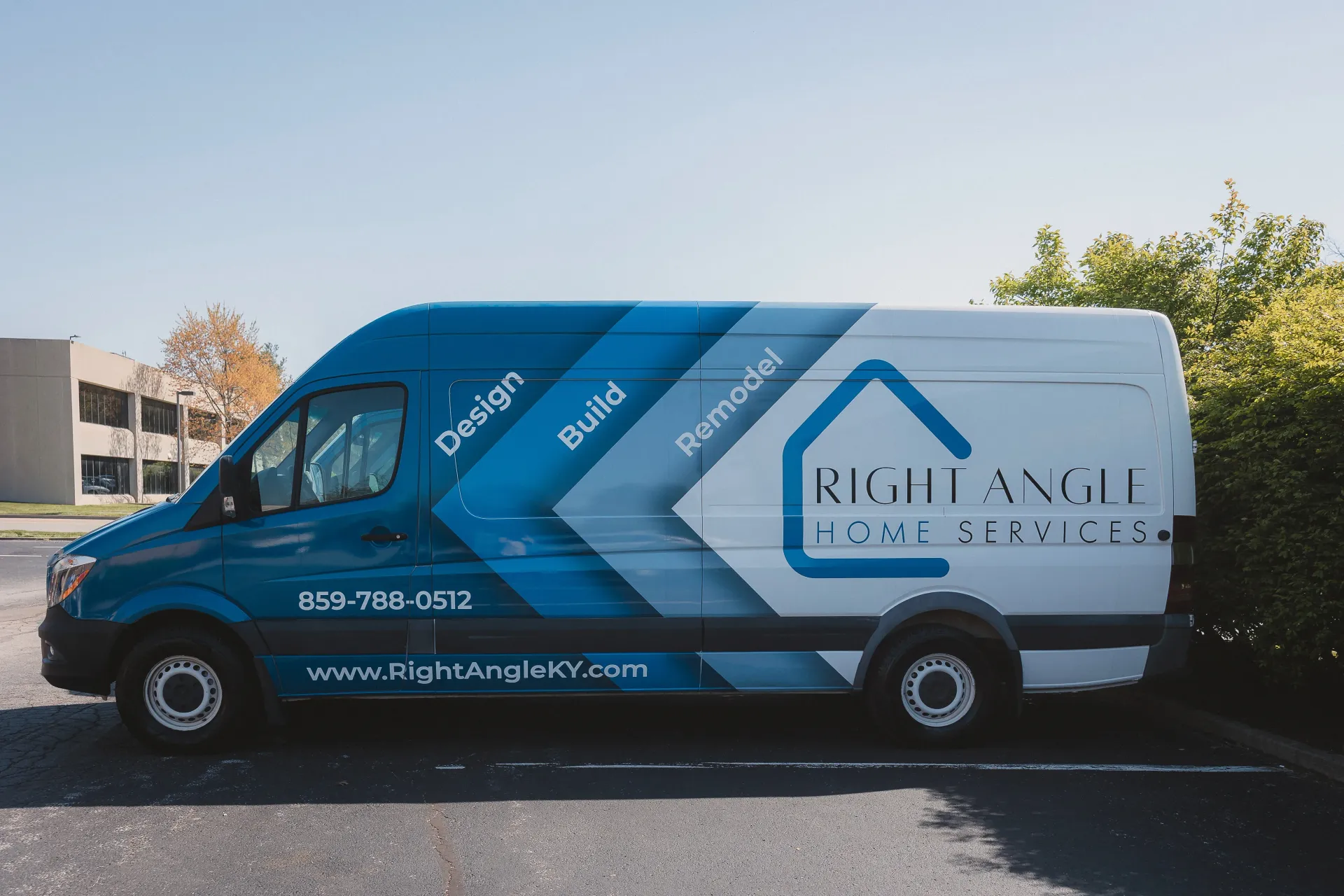 Blue and white Right Angle Remodeling van parked outdoors.