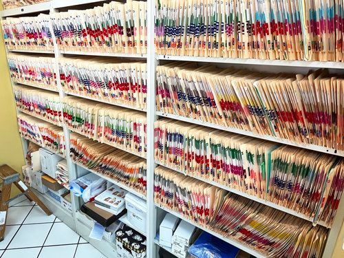 A row of shelves filled with lots of medical records.