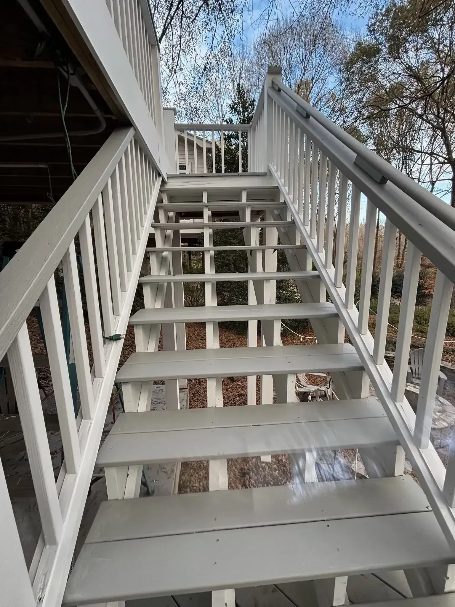 White painted wooden staircase leading upwards.