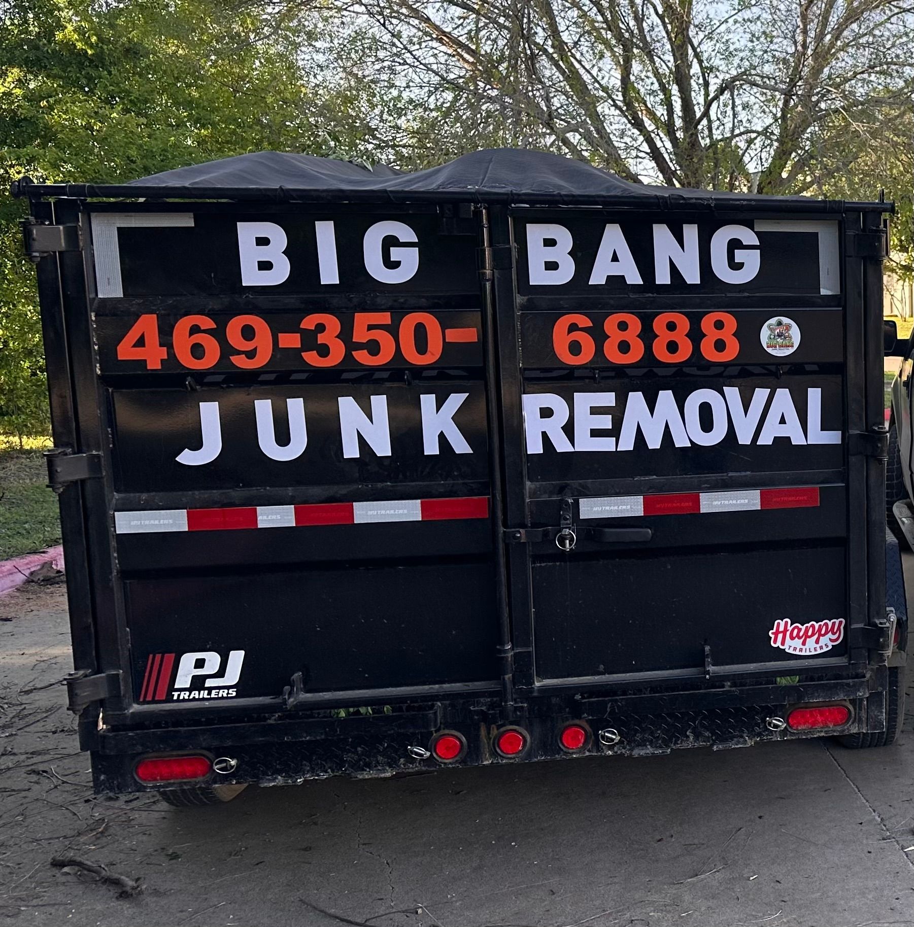 A dumpster that says big bang junk removal on it