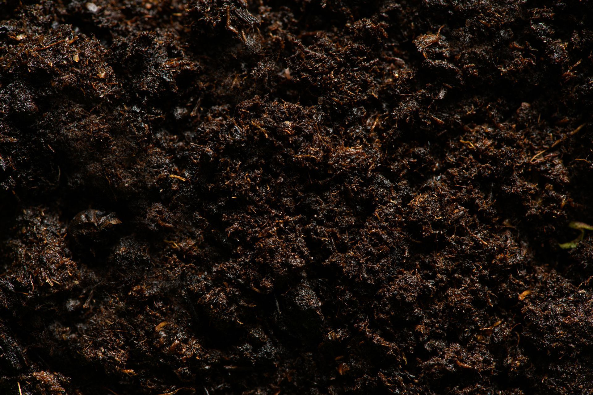 A close up of a pile of dirt with a black background