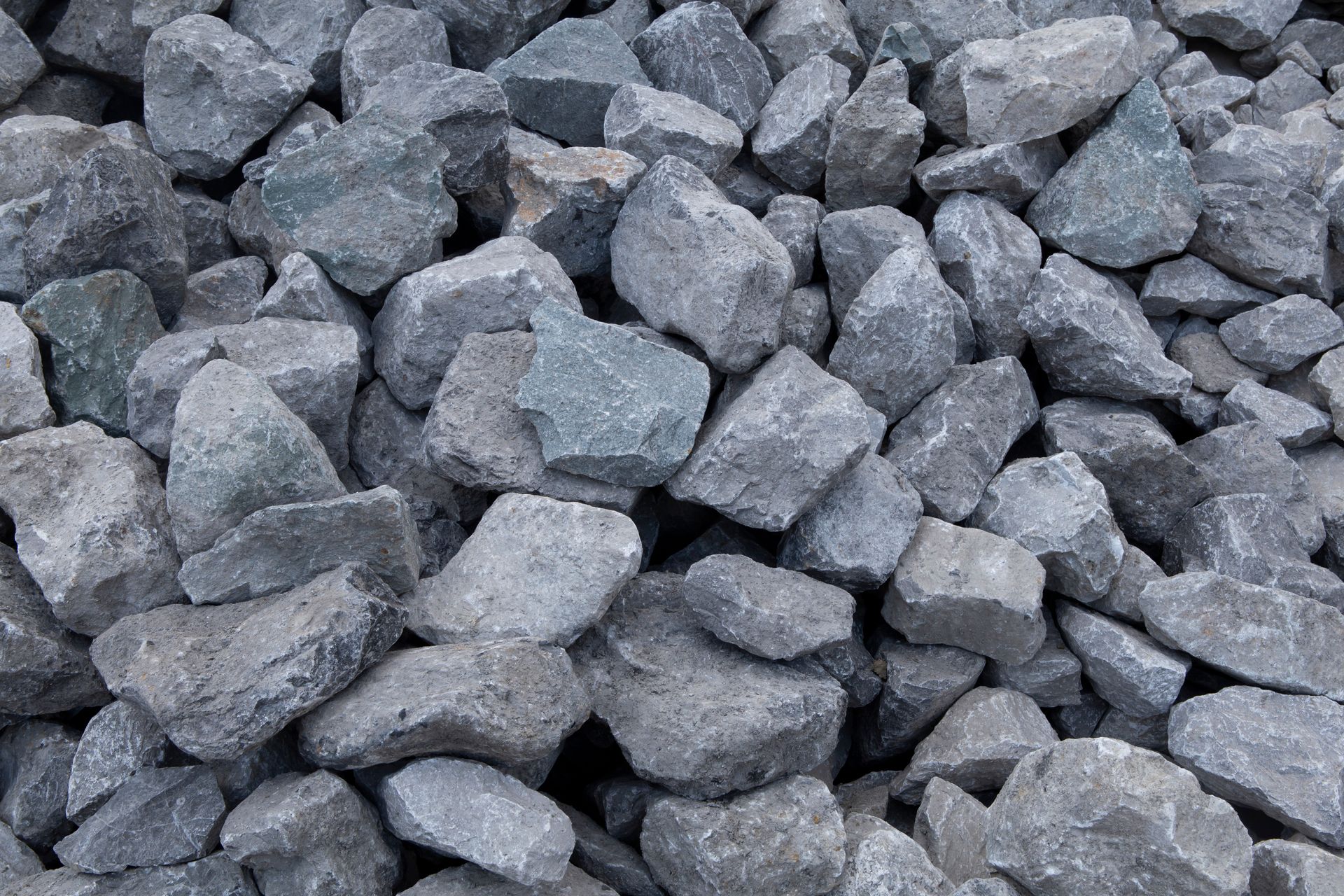 A pile of gray crushed stone gravel used for construction, drainage, or landscaping.