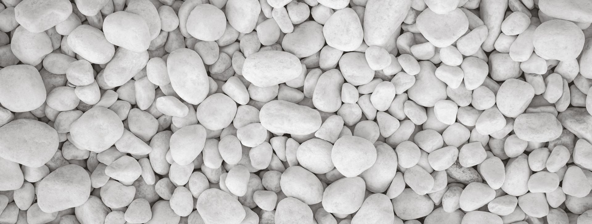 Close-up view of smooth white pebbles arranged tightly together.