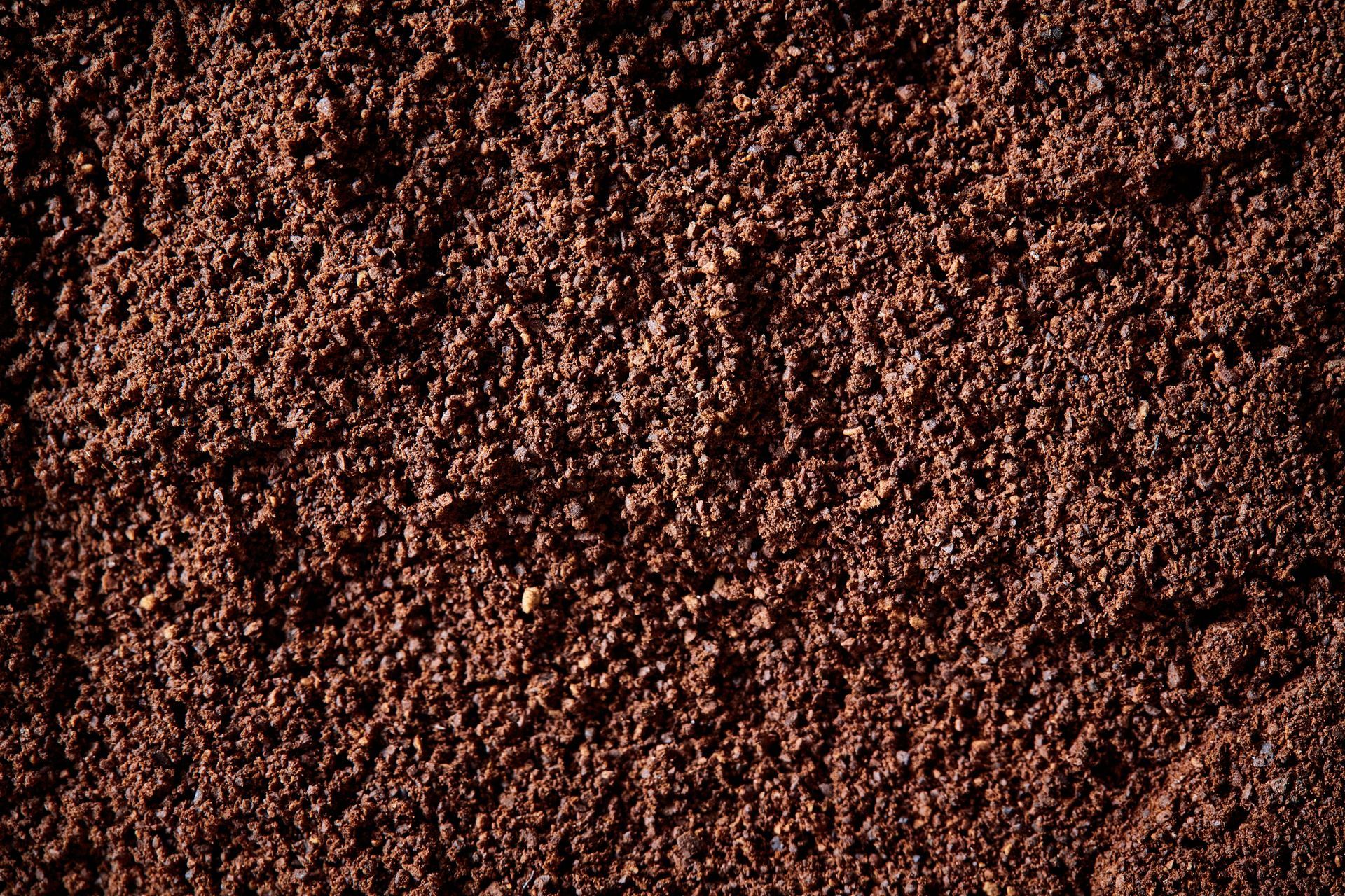 A close up of a pile of brown sand.