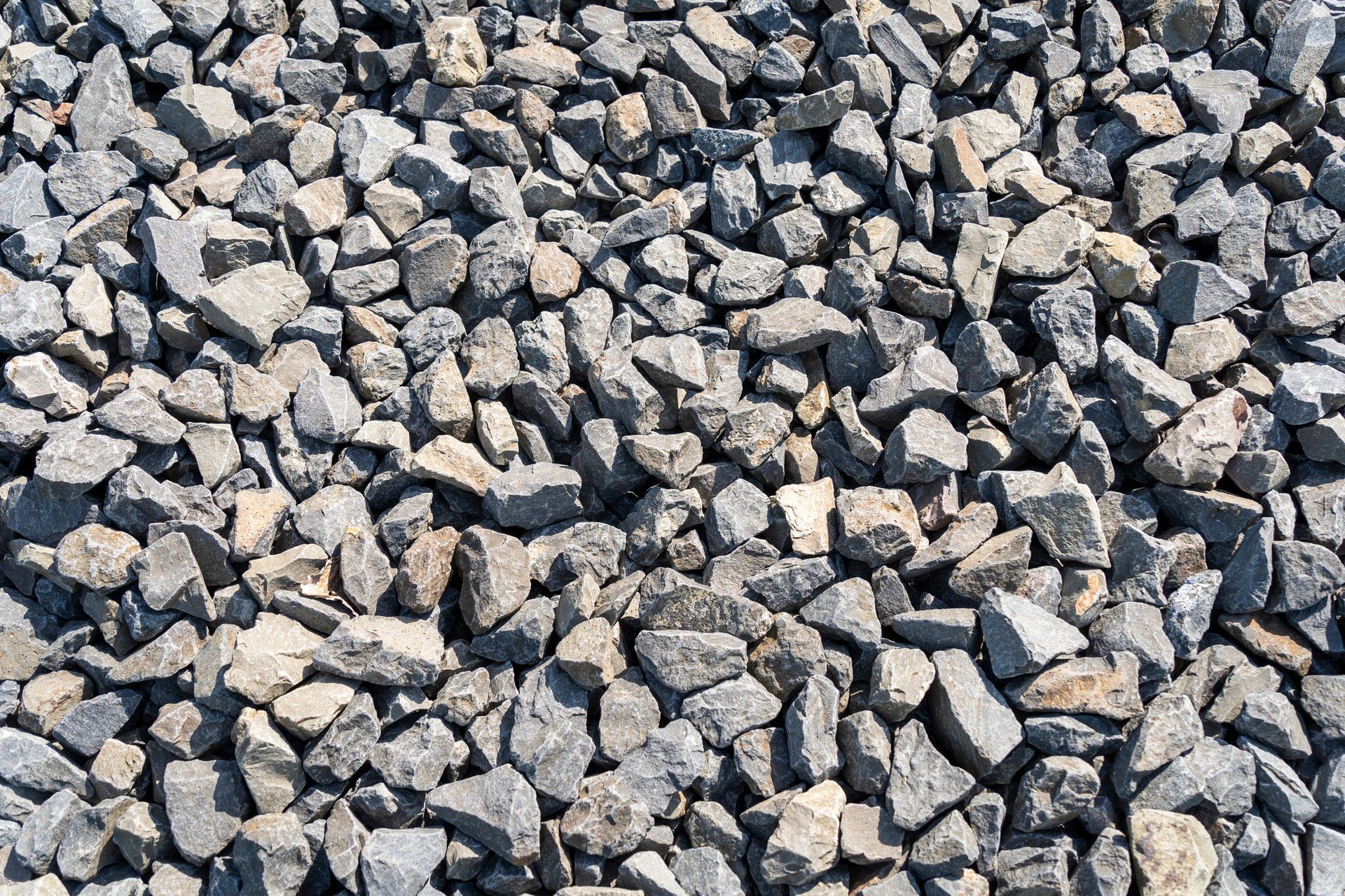 A pile of gravel is sitting on the ground.