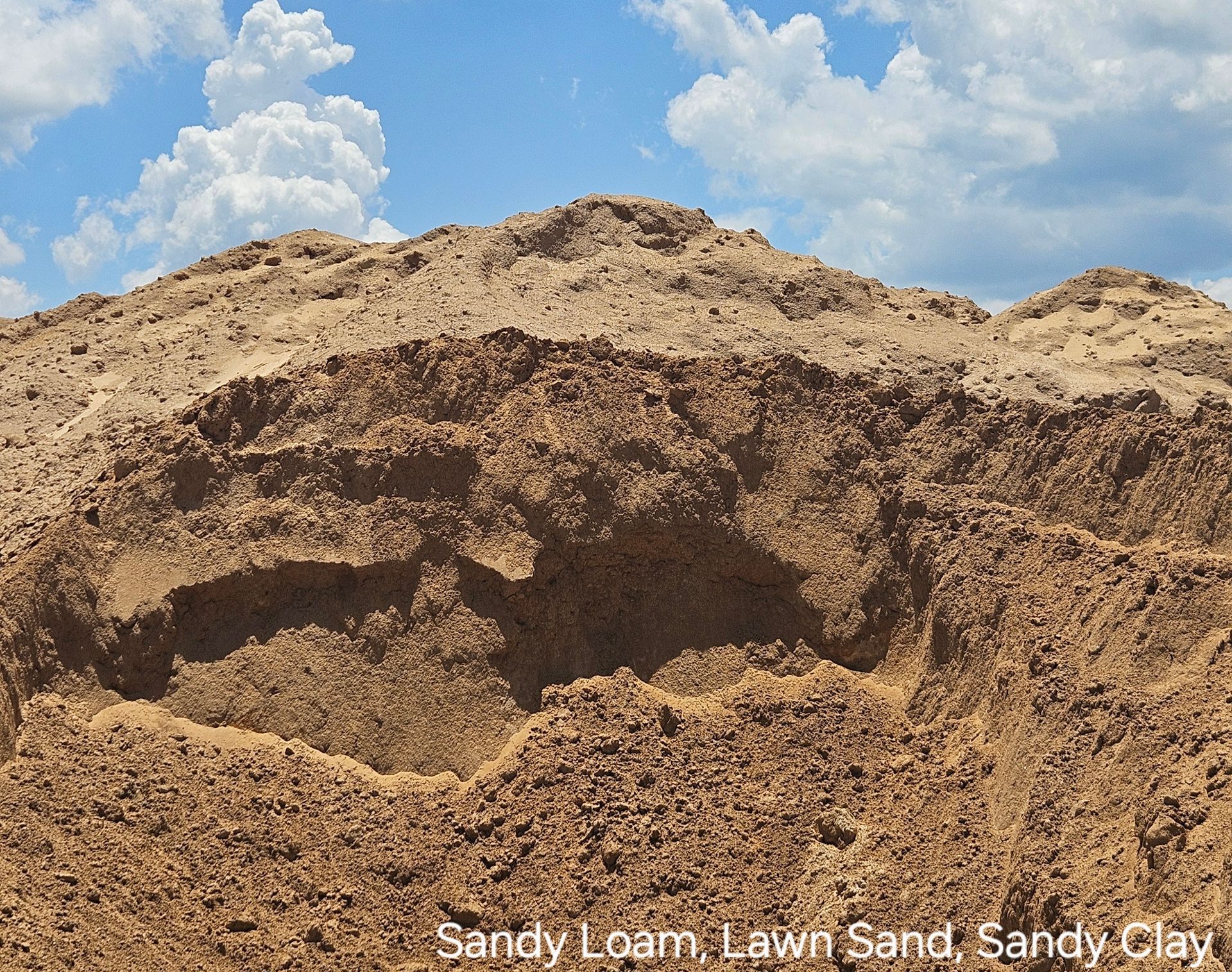 A close up of a gravel driveway next to a lawn.
