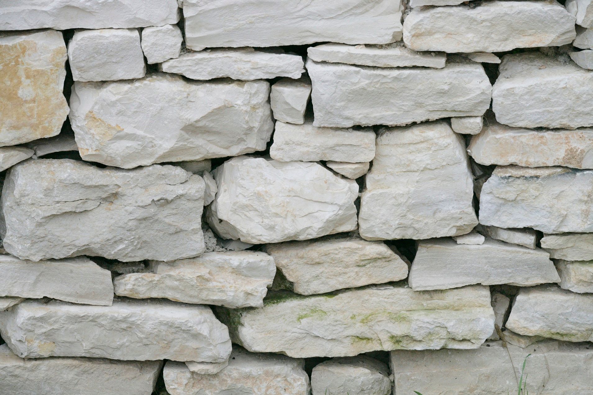A close up of a stone wall made of white rocks