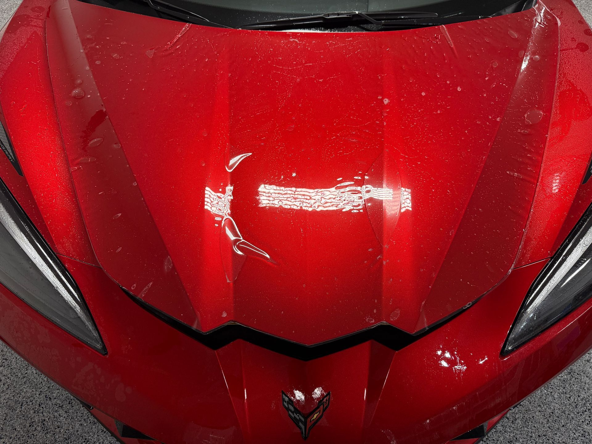 A close up of the front of a red sports car