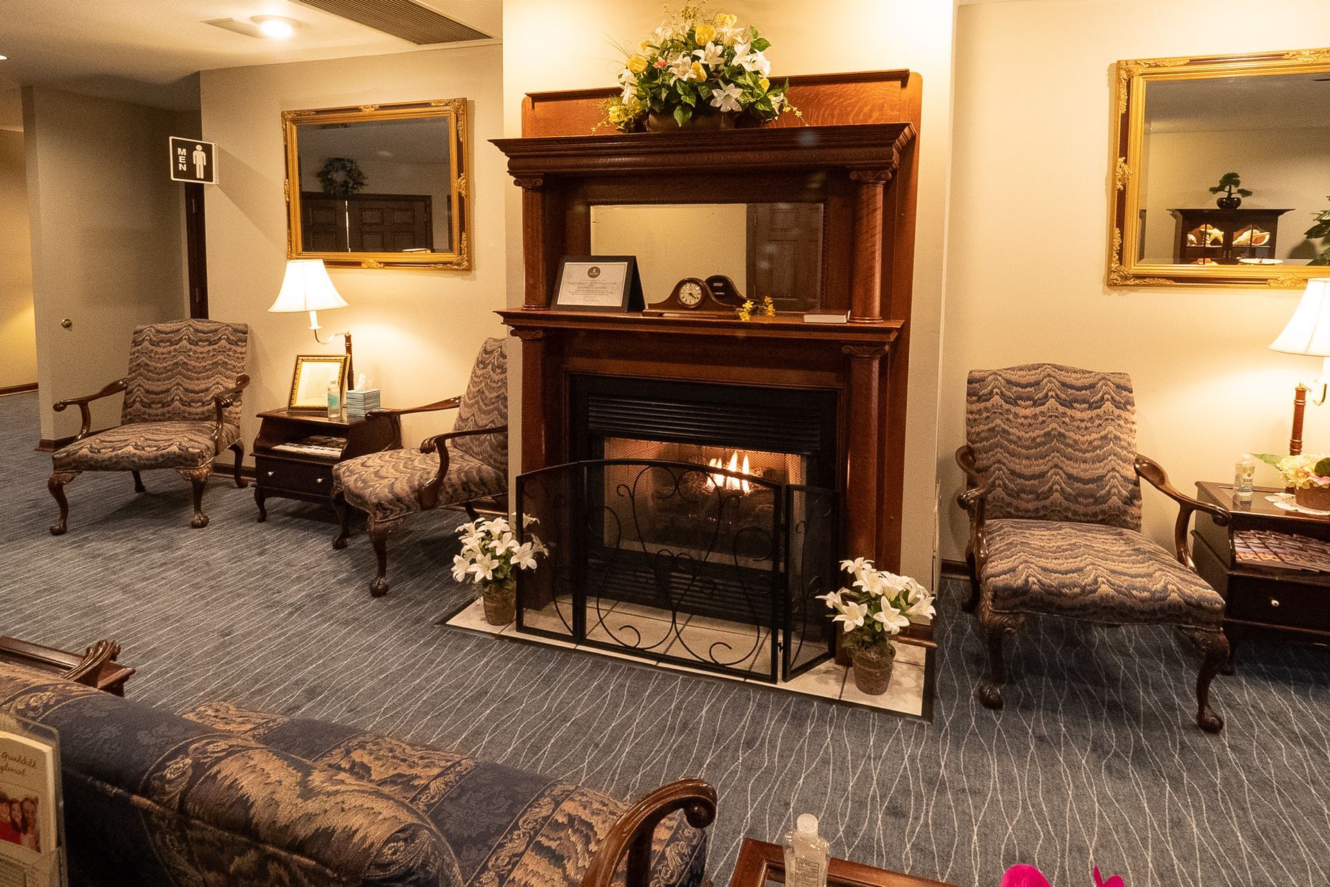 a wooden walkway leading to a gazebo overlooking a body of water at sunset .