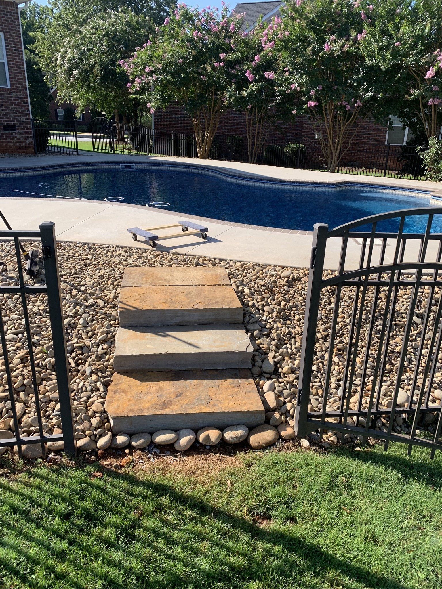 Natural Stone Steps Surrounded by Pea Gravel Leading to Pool