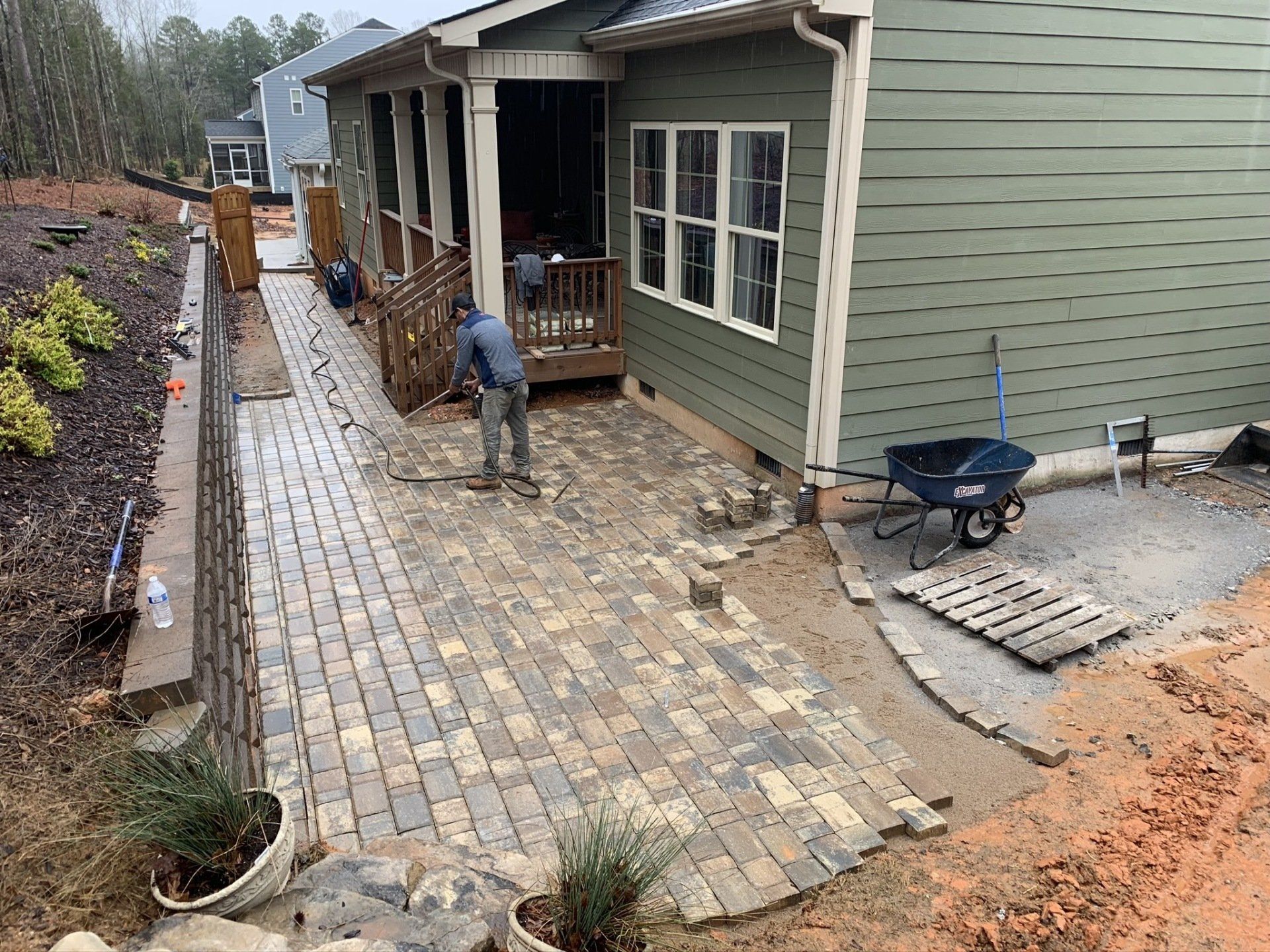 Hardscape Contractor Installing Brick Pavers on Side of Home