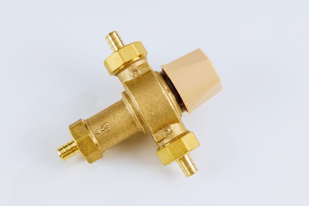 A Close Up of a Brass Valve on a White Surface — Ryno's Plumbing Group in Lakewood, NSW