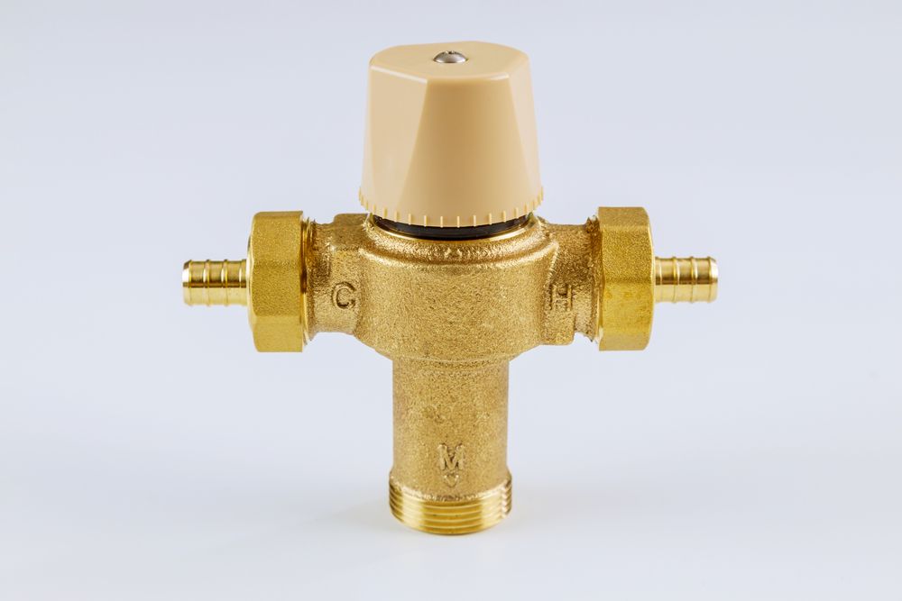 A Close Up of a Thermostatic Valve on a White Surface — Ryno's Plumbing Group in Lakewood, NSW