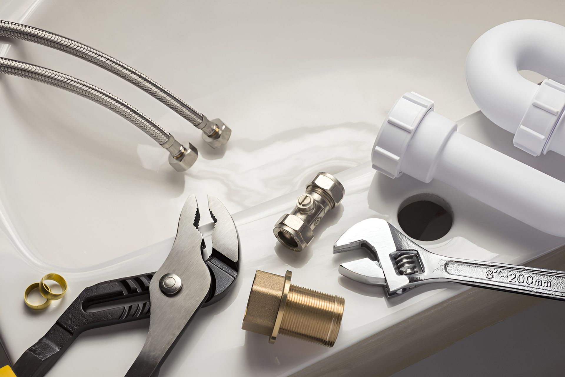 A Sink With a Wrench and Pliers on It — Ryno's Plumbing Group in Taree, NSW