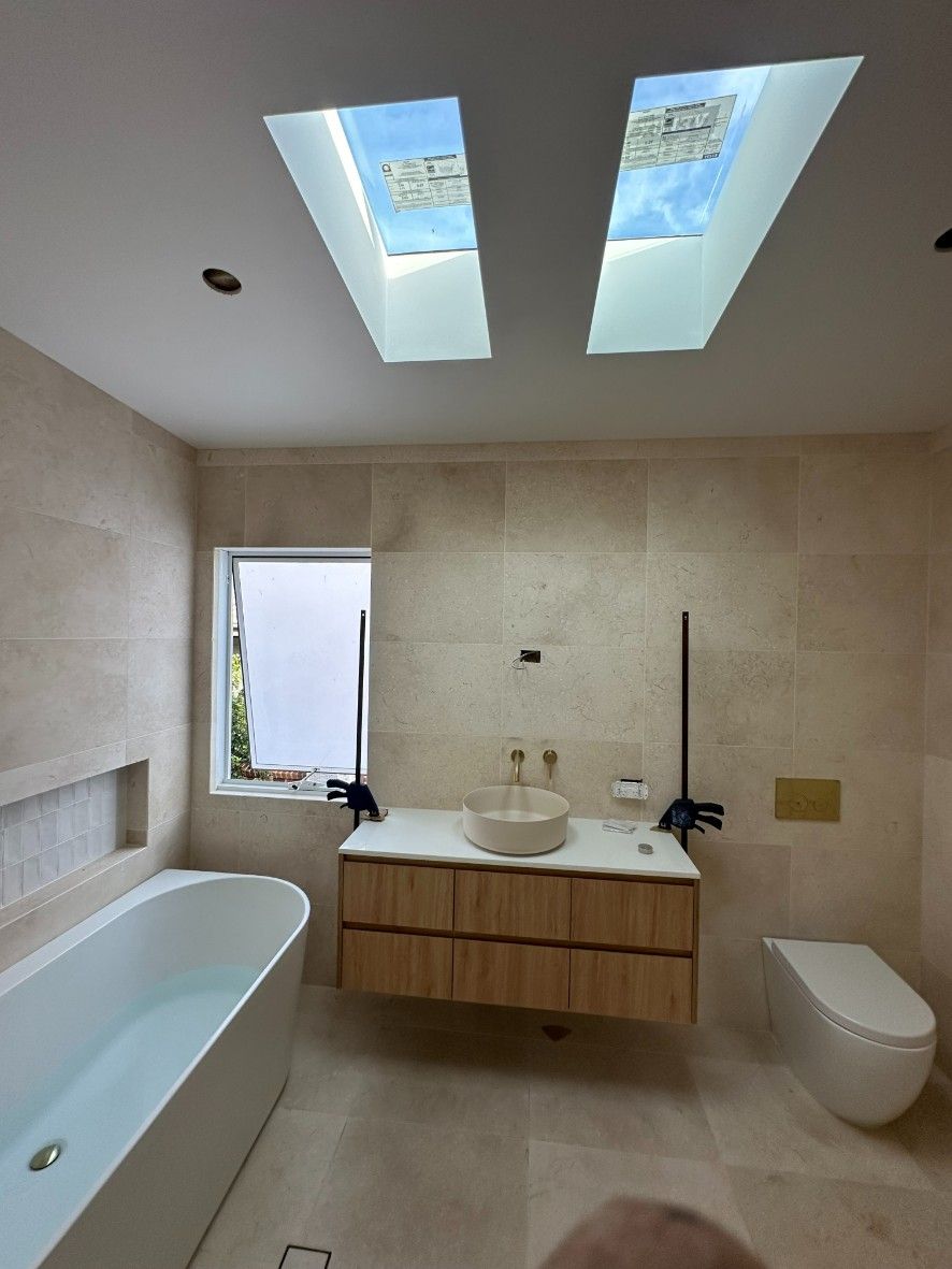A Bathroom With Two Skylights Above the Sink — Ryno's Plumbing Group in Forster, NSW