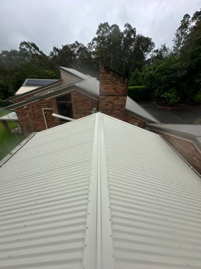 A White Roof of a House With Trees in the Background — Ryno's Plumbing Group in Lakewood, NSW