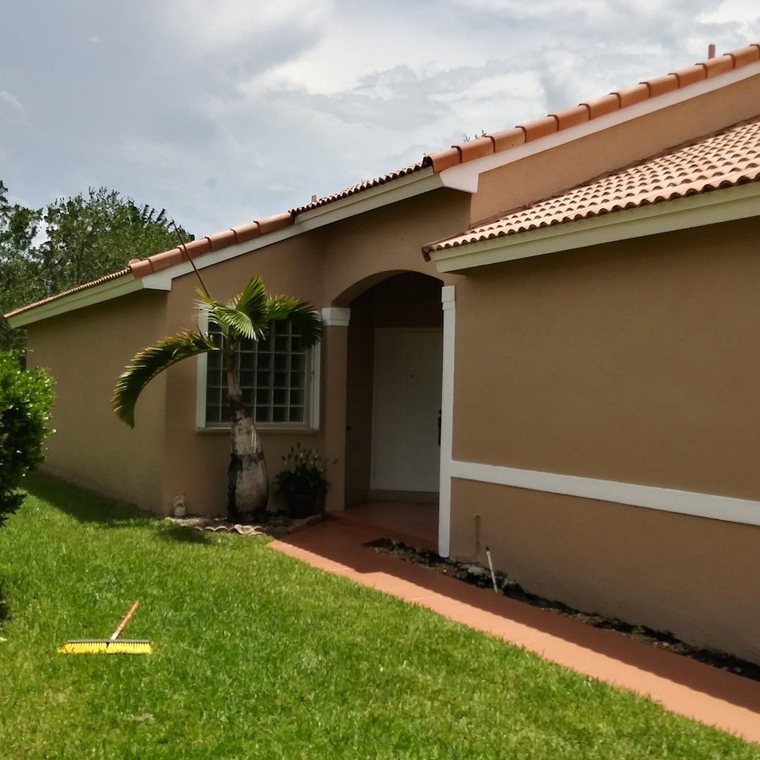 A house with a lawn mower in front of it