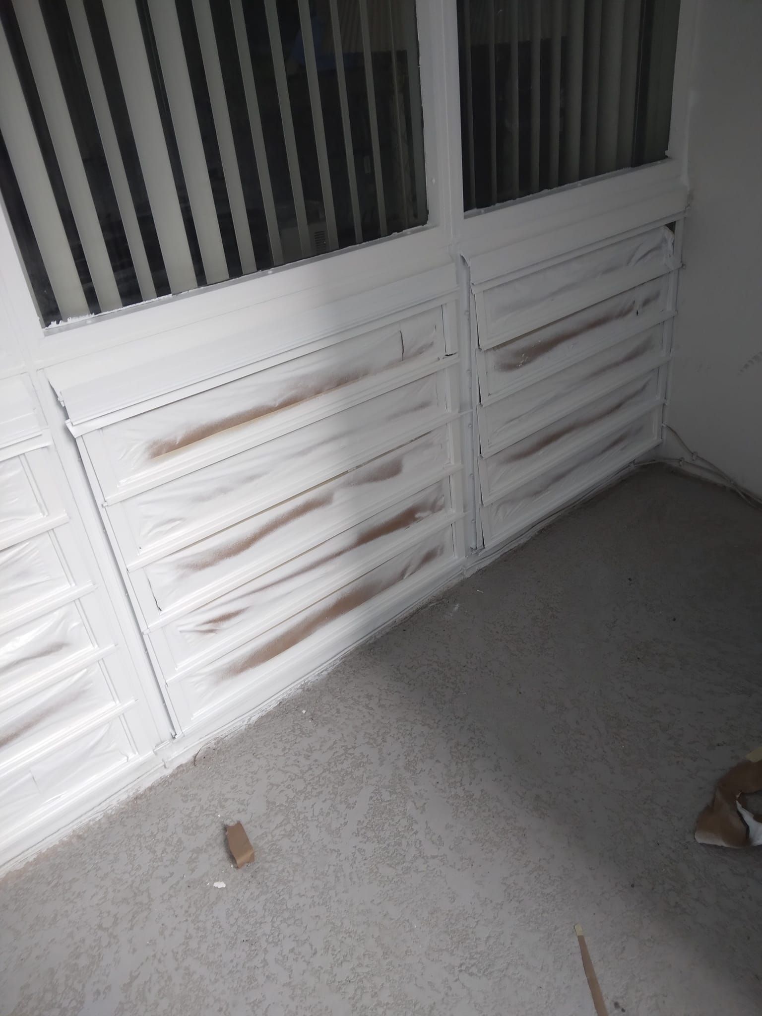 A room with a lot of drawers and a window.