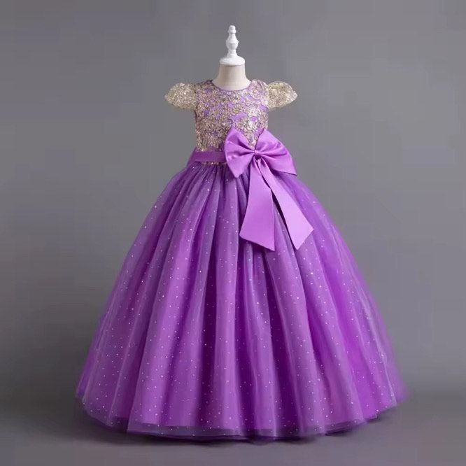 A purple dress with a bow is on a mannequin.