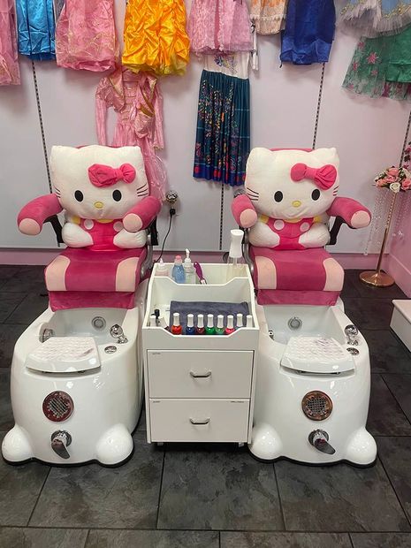 Two hello kitty chairs are sitting next to each other in a room.