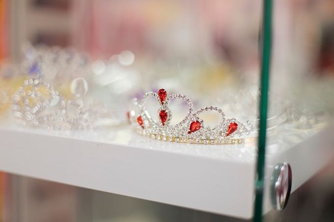 A close up of a crown on a glass shelf in a store.