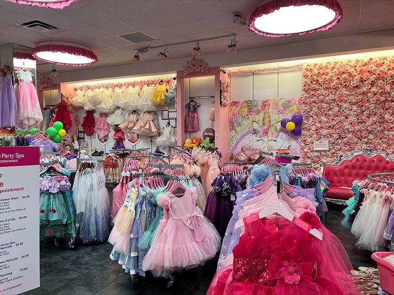 A store filled with lots of dresses and balloons.