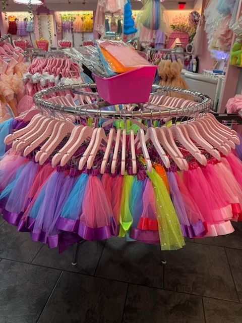A children 's clothing store with a lot of clothes on display.