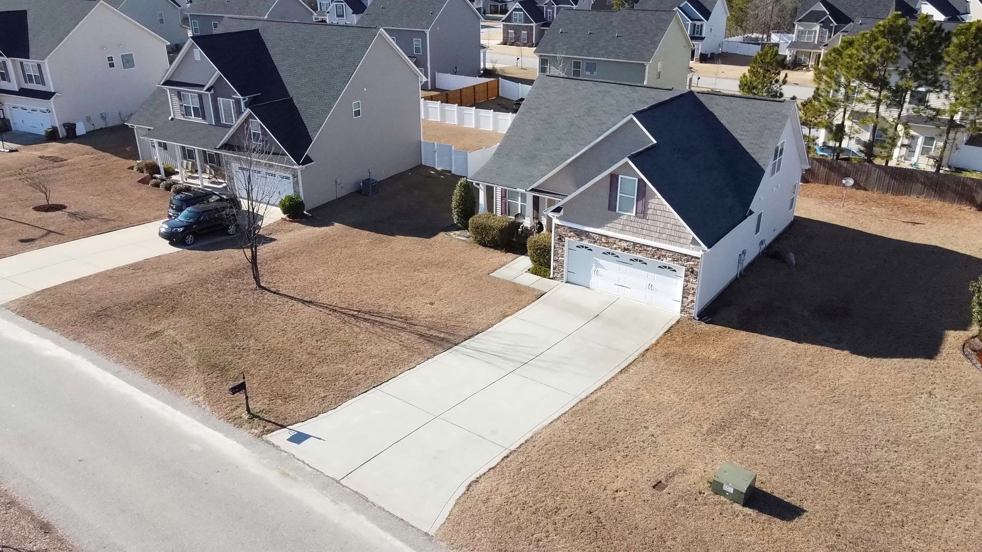 An aerial view of a residential neighborhood with houses and driveways