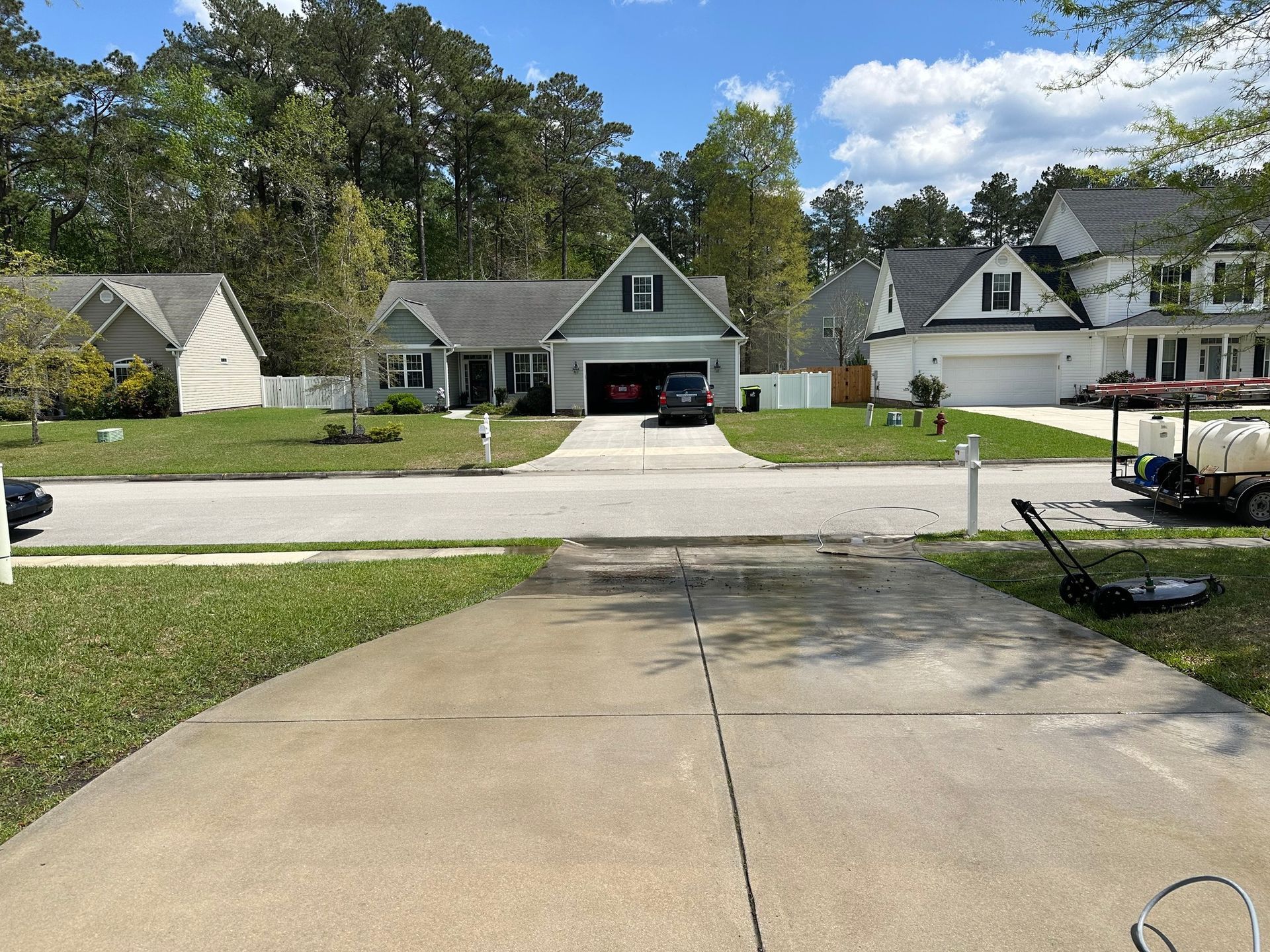 A driveway leading to a house in a residential neighborhood.