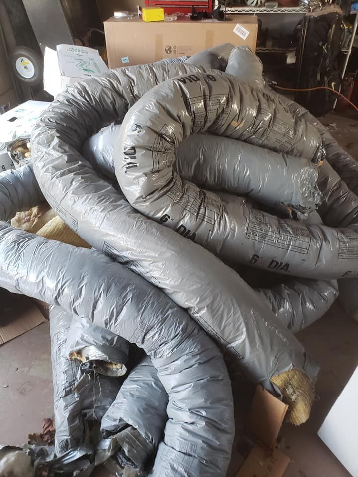 A bunch of ducts are stacked on top of each other in a room.