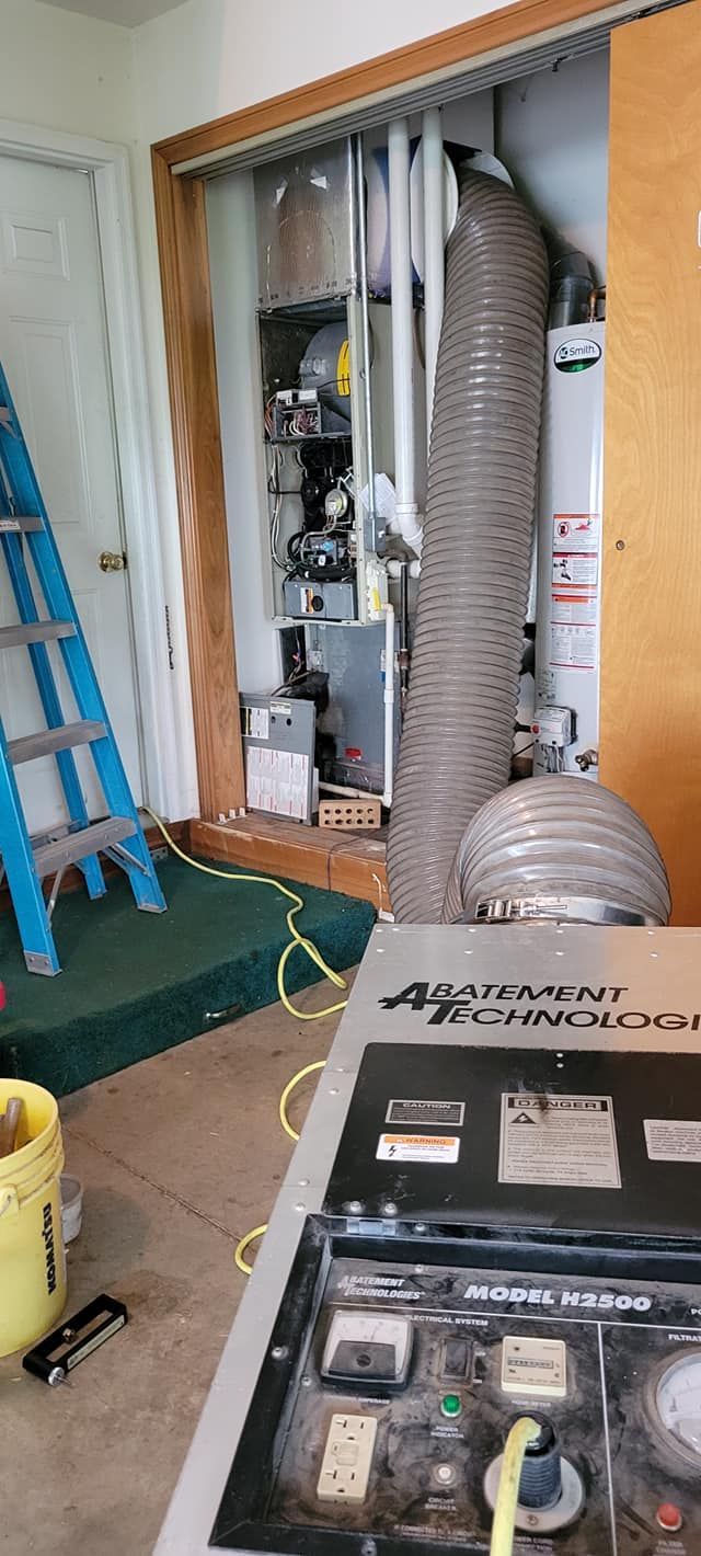 A vacuum cleaner is sitting in a room next to a ladder.