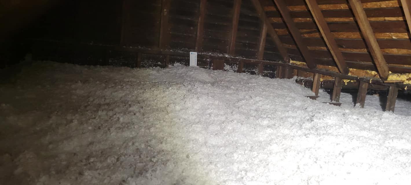 There is a lot of insulation in the attic of a house.