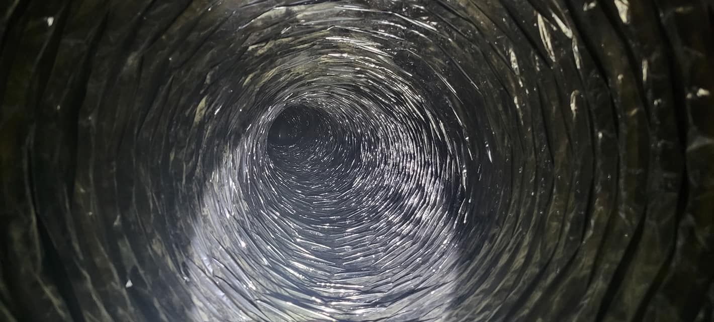A close up of the inside of a metal pipe.