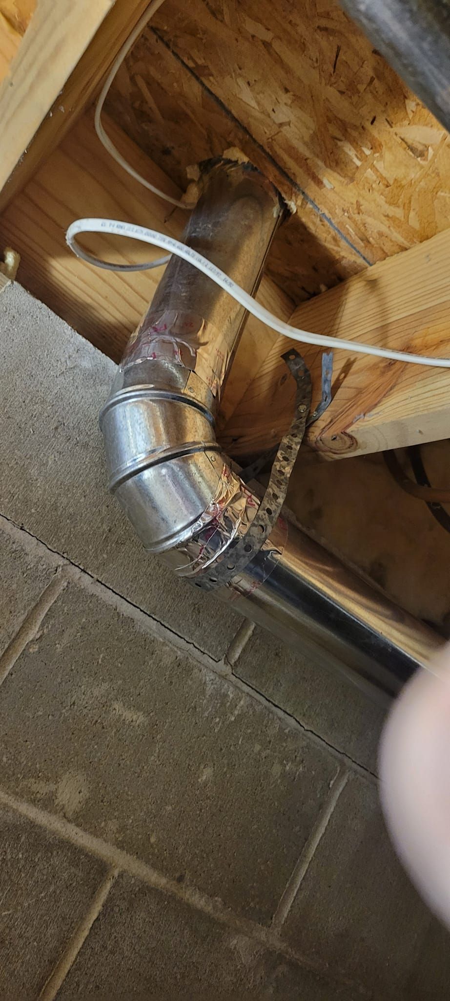 A person is holding a piece of metal in their hand.