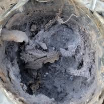 A close up of a vacuum cleaner with a lot of dust in it.