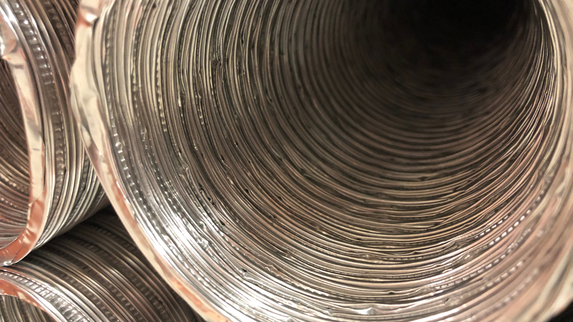 A close up of a metal pipe stacked on top of each other.
