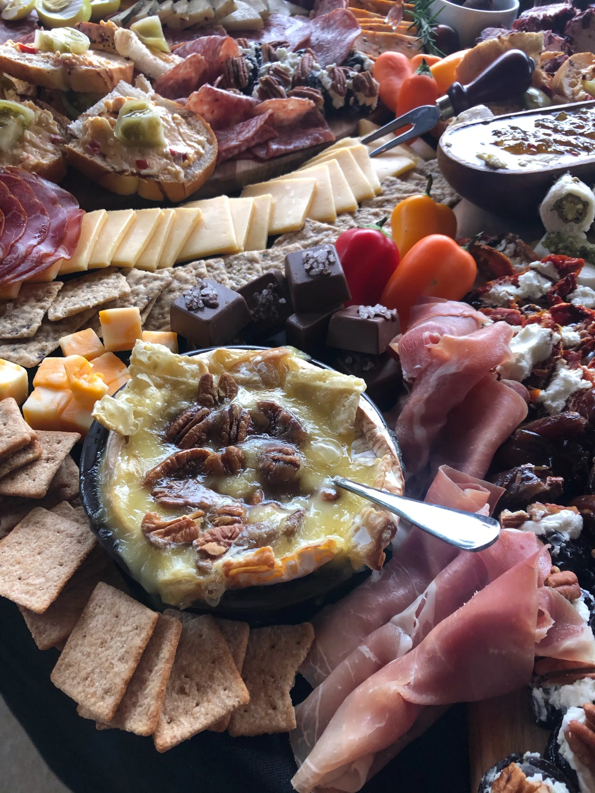 charcuterie-board-with-assorted-cheeses-proscuitto-crackers