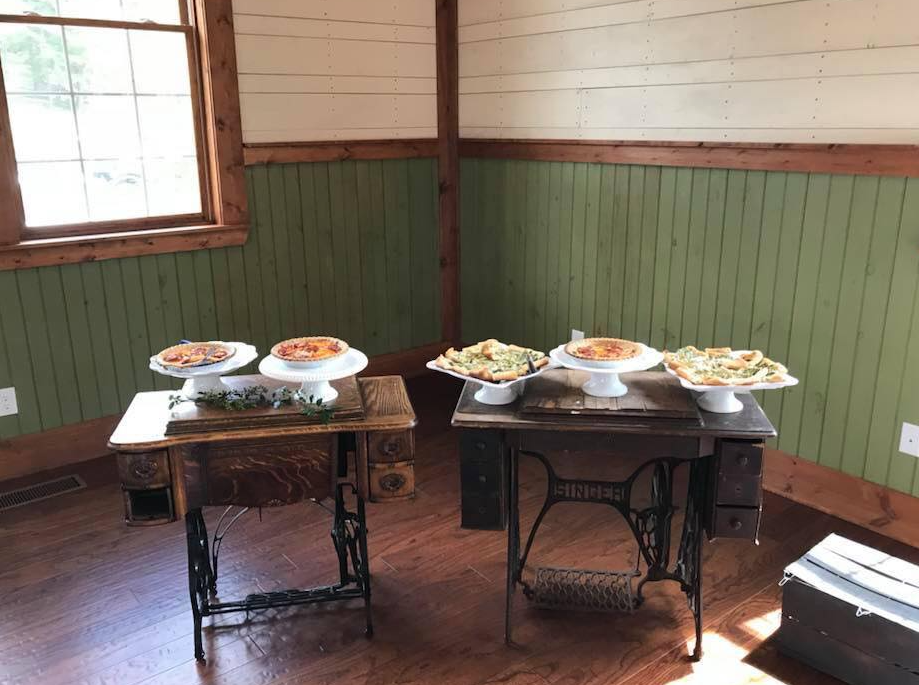 homemade-pies-on-white-pedestal-stands-staged-on-old-wooden-school-desks