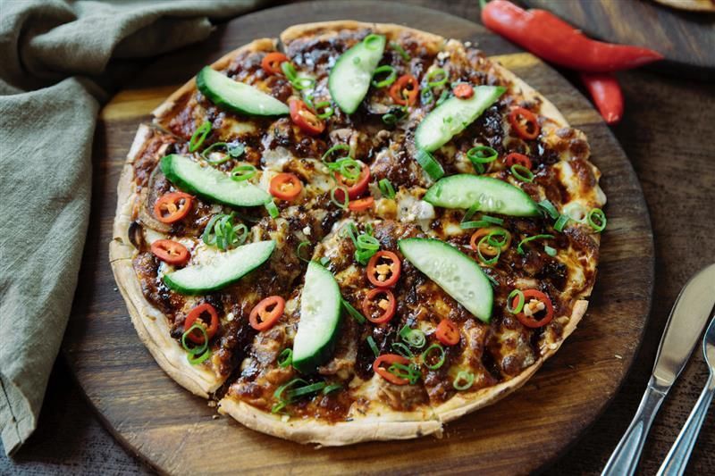 A Close Up of a cocktail with straws in a persons hand — Zachary's in Noosaville, QLD