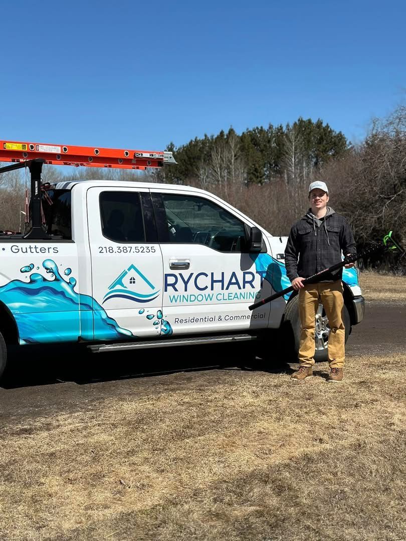 Man standing by white truck with pool cleaning logo; outdoors.